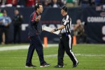 Texans coach Gary Kubiak discusses a call with side judge Jimmy DeBell. (Houston Texans photo)