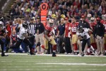 Line judge Byron Boston follows 49ers tight end Vernon Davis (San Francisco 49ers photo)
