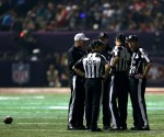 The officiating crew is joined by alternate Bill Vinovich (black jacket) during the third quarter power outage. (Ben Liebenberg/NFL)