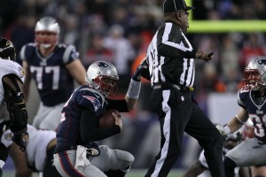 Umpire Chad Brown tries (unsuccessfully) to get out of the way of Patriots quarterback Tom Brady. (David Silverman/New England Patriots)